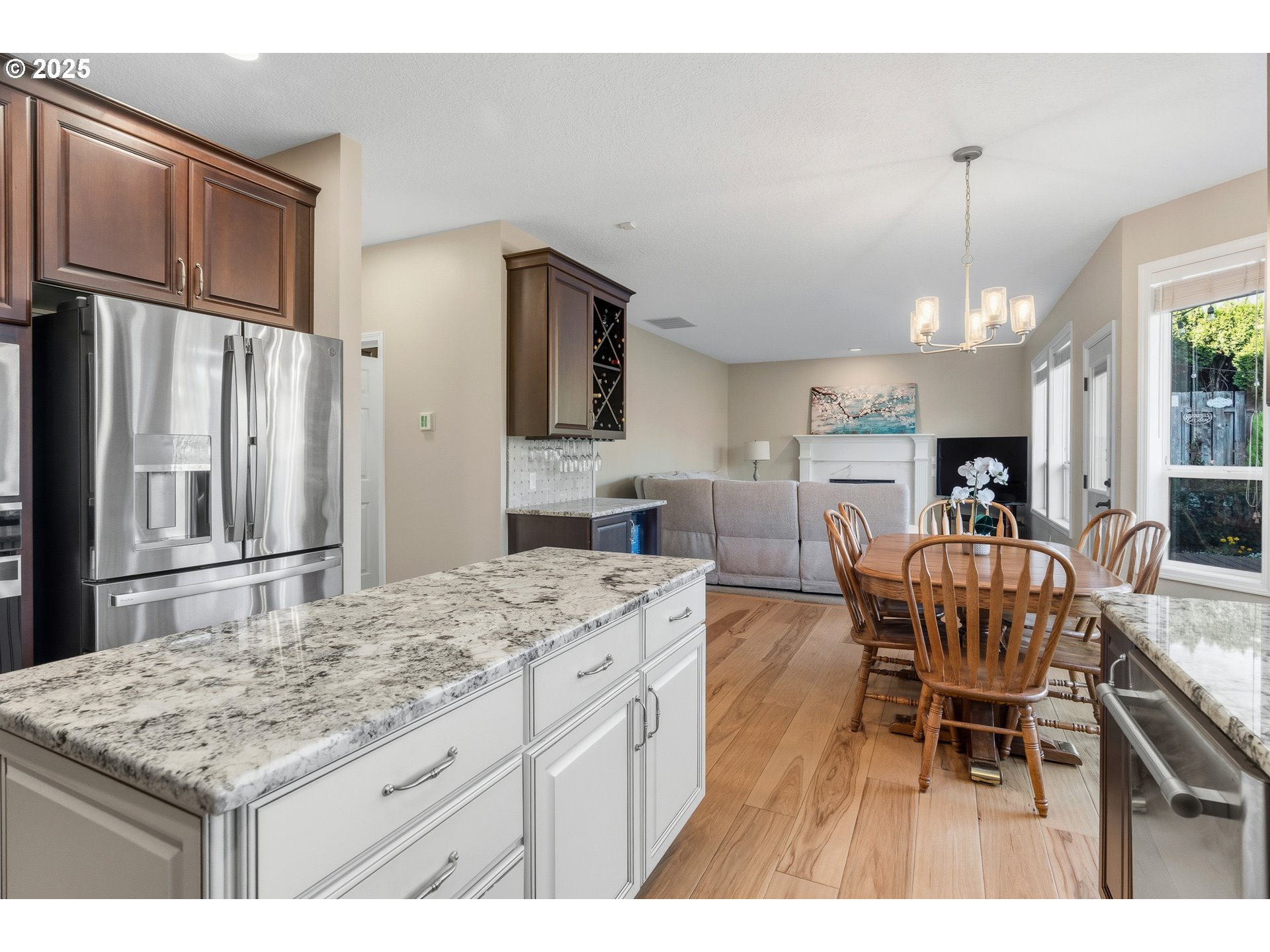 20194 Canyon Ridge Drive Oregon City, OR 97045 - Photo 8 of 41 a kitchen with stainless steel appliances kitchen island granite countertop a table chairs and a refrigerator