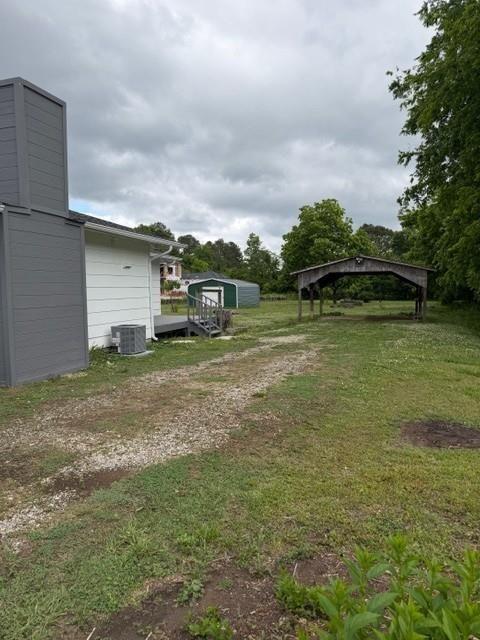 4006 North Arnold Mill Road Woodstock, GA 30188 - Photo 17 of 18 a view of a water house with a big yard and large trees
