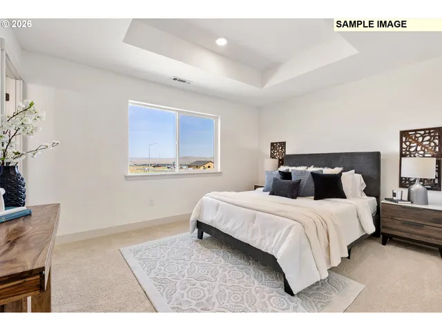 a bedroom with a bed and a night stand