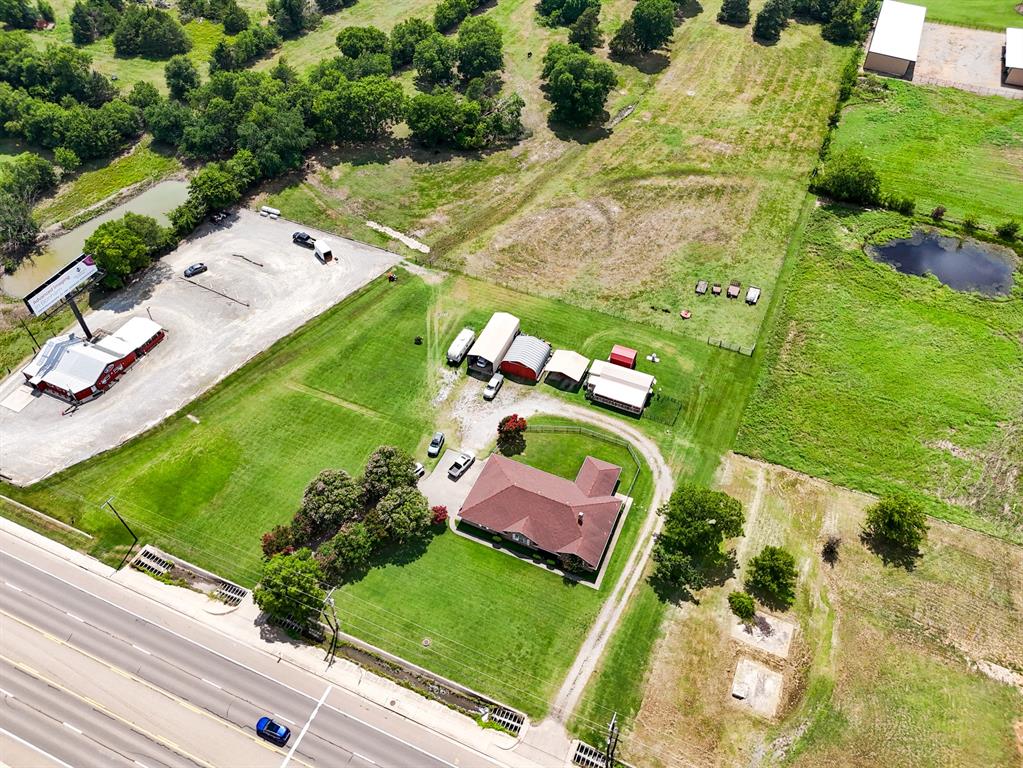 1709 Highway 121 Bonham, TX 75418 - Photo 4 of 19 an aerial view of a pool yard swimming pool and outdoor seating