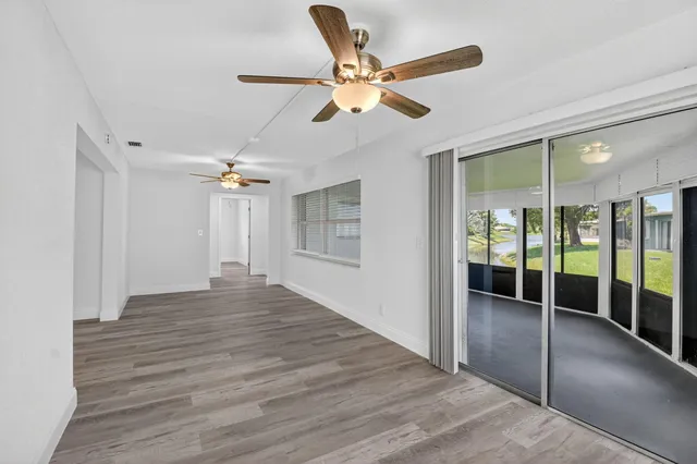 a view of a livingroom with a ceiling fan and hardwood floor