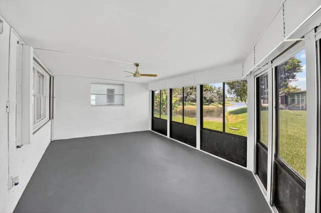 a view of an empty room with windows