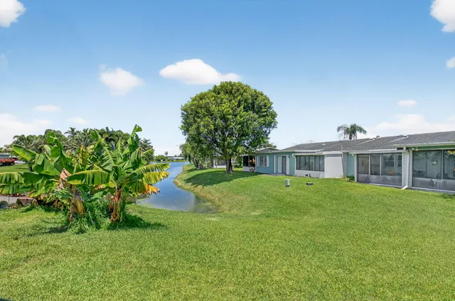 a view of house with a big yard