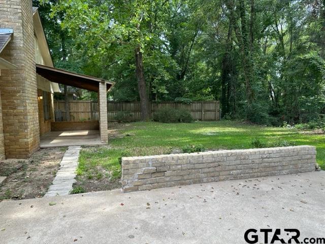 2611 South Boldt Avenue Tyler, TX 75701 - Photo 13 of 14 a view of a house with a yard and large tree