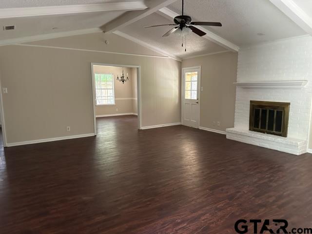 2611 South Boldt Avenue Tyler, TX 75701 - Photo 2 of 14 an empty room with wooden floor chandelier fan and windows
