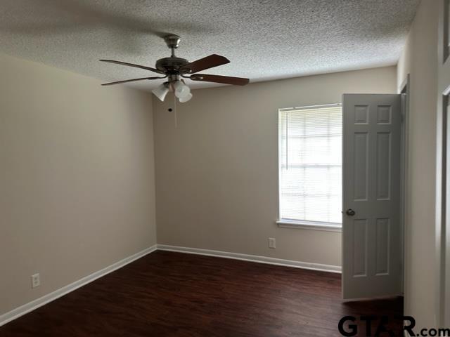 2611 South Boldt Avenue Tyler, TX 75701 - Photo 6 of 14 an empty room with wooden floor closet and windows