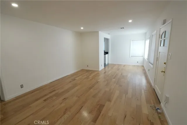 a view of hallway with wooden floor