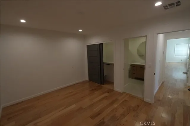 a view of hallway with wooden floor