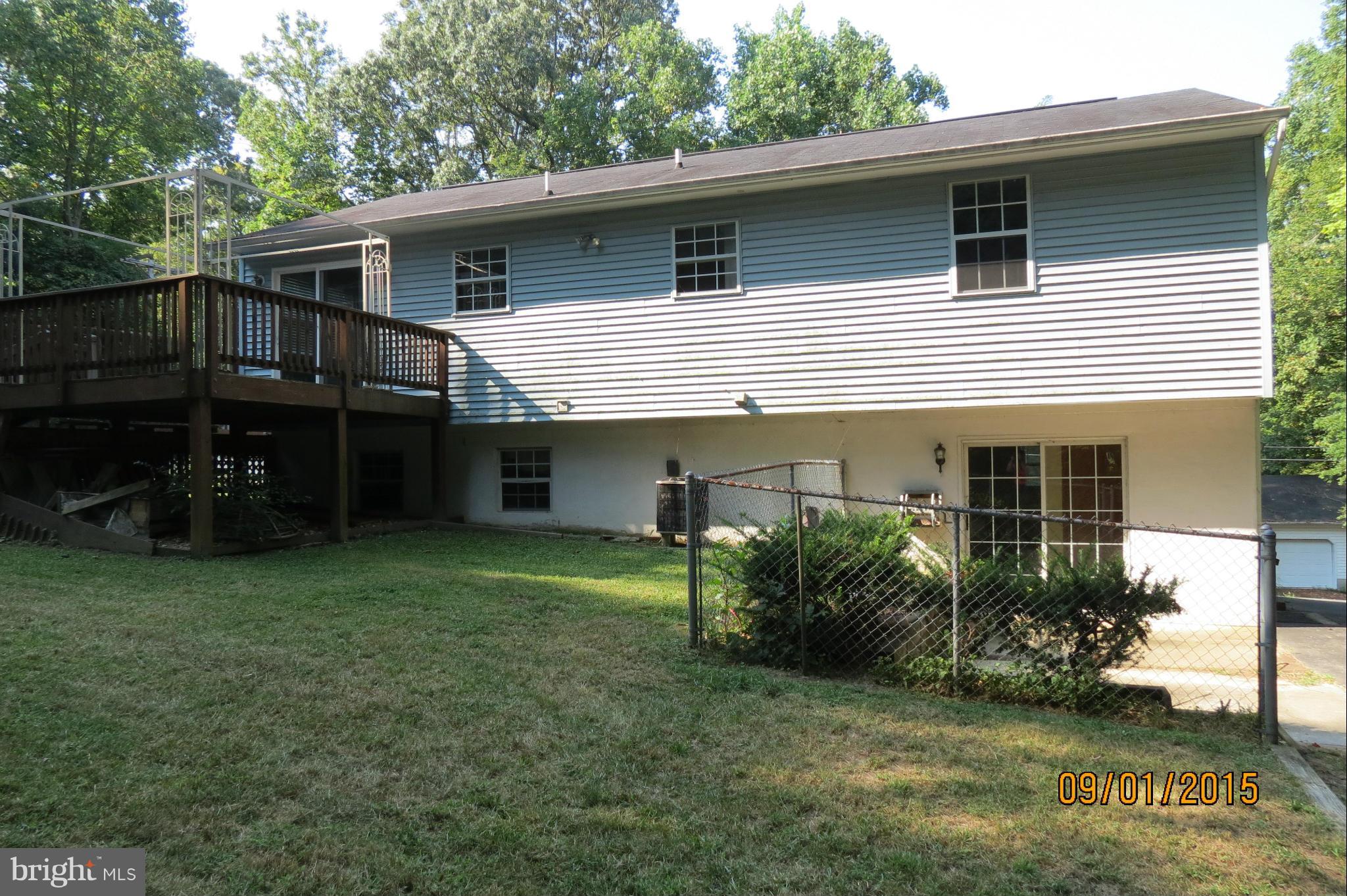 6056 Locust Road St. Leonard, MD 20685 - Photo 9 of 10 a front view of a house with a garden