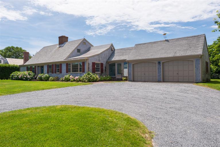 157 Shore Road Chatham, MA 02633 - Photo 3 of 11 a front view of a house with a yard and garage