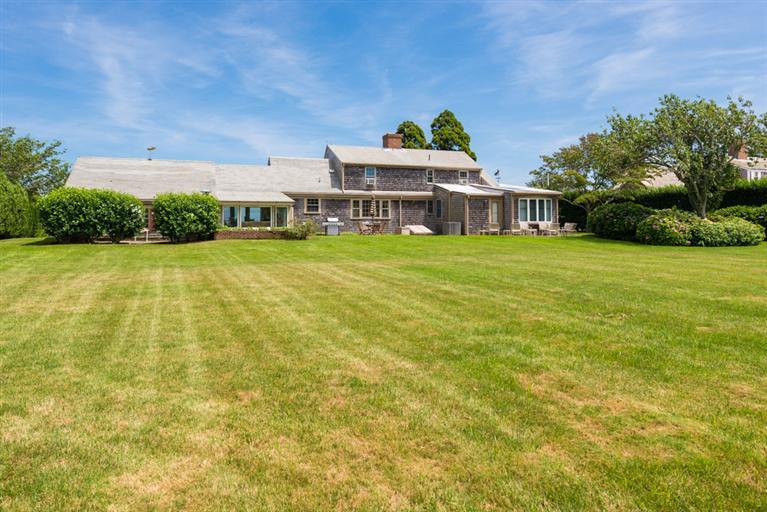 157 Shore Road Chatham, MA 02633 - Photo 6 of 11 a front view of house with an outdoor space and seating