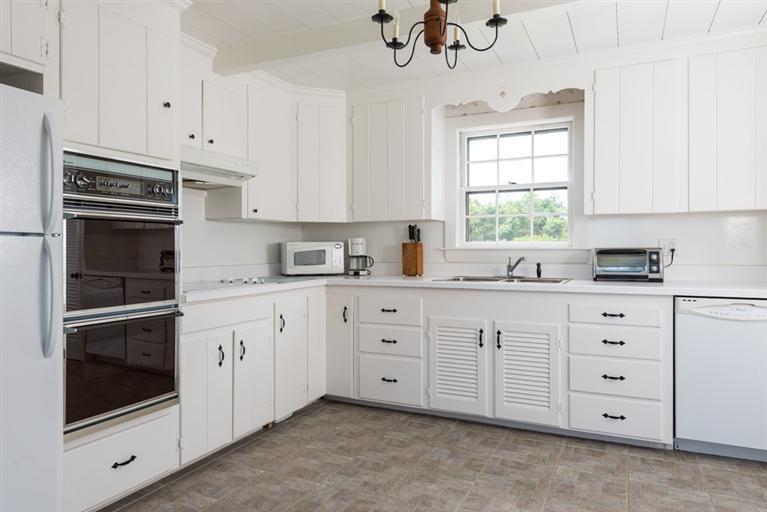 157 Shore Road Chatham, MA 02633 - Photo 7 of 11 a kitchen with cabinets stainless steel appliances and a window
