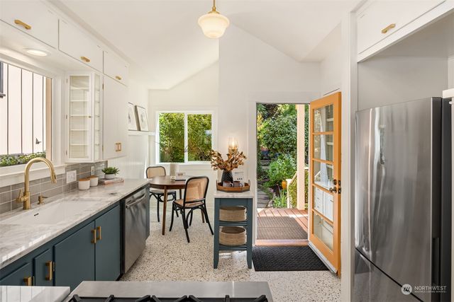 a dining room with furniture and a large window