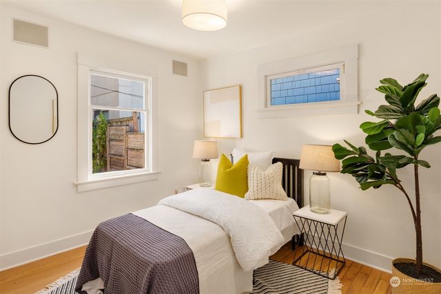a bedroom with a bed and a potted plant