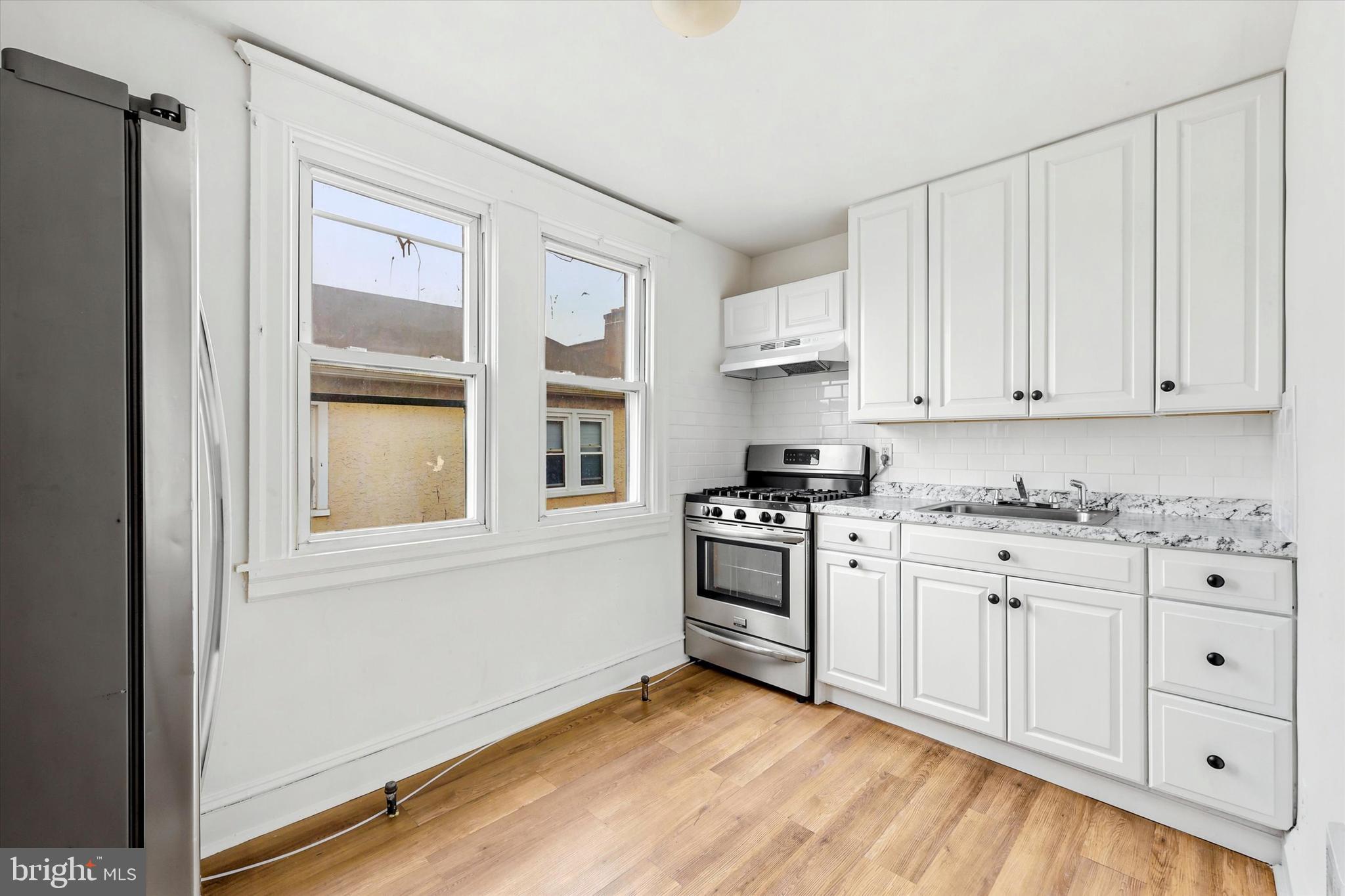 55 Richfield Road Upper Darby, PA 19082 - Photo 20 of 33 a kitchen with granite countertop white cabinets and stainless steel appliances