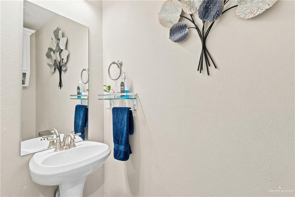 1904 Ridgeway Circle Edinburg, TX 78542 - Photo 22 of 32 Pedestal sink with a brushed nickel faucet and a frameless mirror