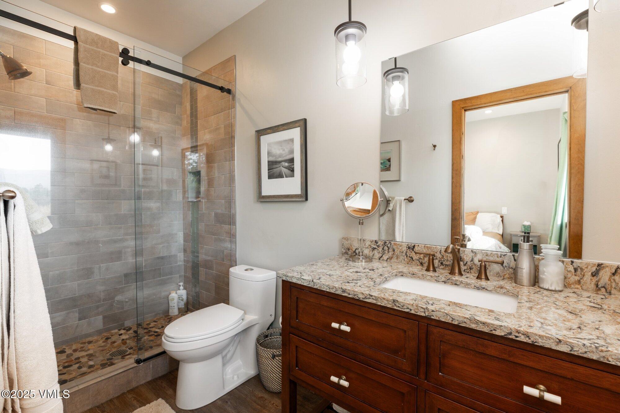 948 Wolcott Springs Road Wolcott, CO 81655 - Photo 43 of 49 a bathroom with a granite countertop sink toilet and shower