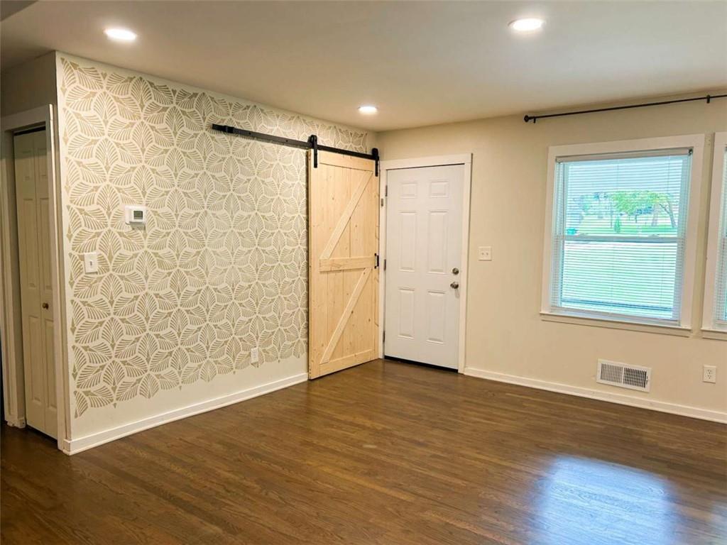 811 Cinderella Way Decatur, GA 30033 - Photo 14 of 33 a view of an empty room with wooden floor and a window