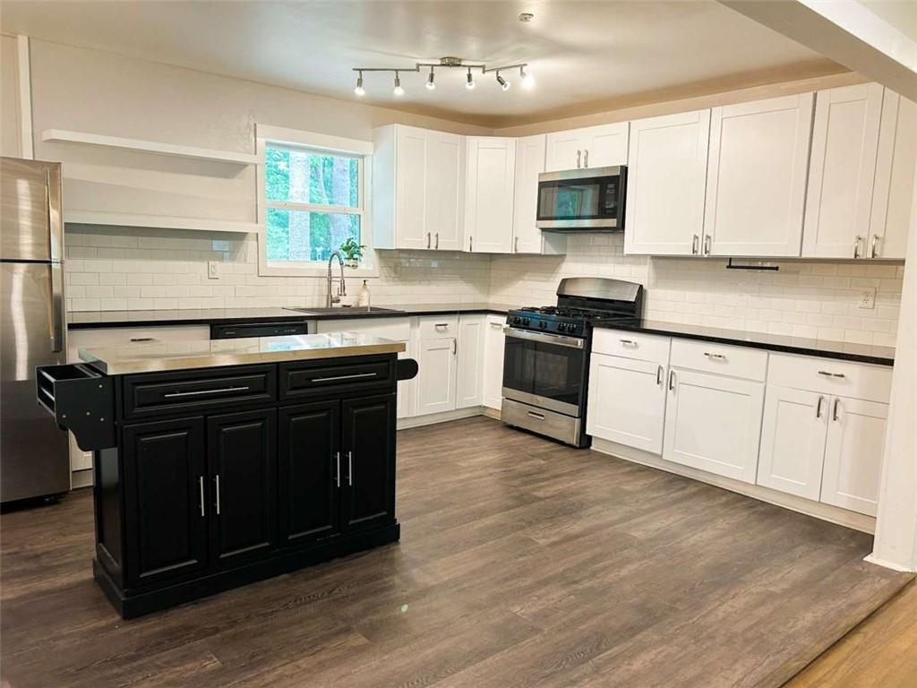 811 Cinderella Way Decatur, GA 30033 - Photo 8 of 33 a kitchen with granite countertop a stove a sink and a microwave