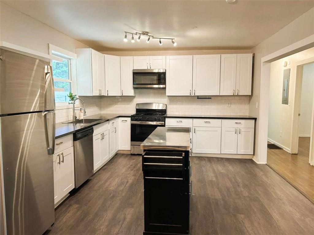 811 Cinderella Way Decatur, GA 30033 - Photo 9 of 33 a kitchen with cabinets stainless steel appliances and a window
