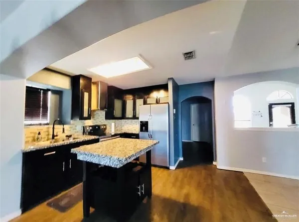 a kitchen with a sink and a refrigerator