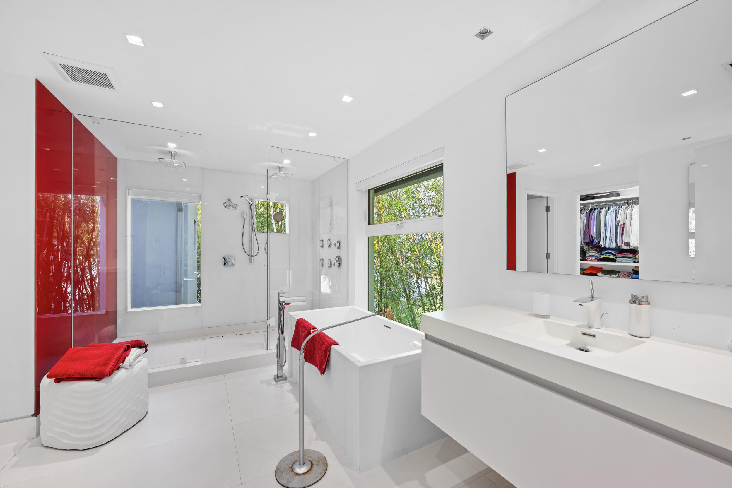 7047 San Sebastian Circle Boca Raton, FL 33433 - Photo 36 of 95 a bathroom with a bathtub sink vanity and mirror