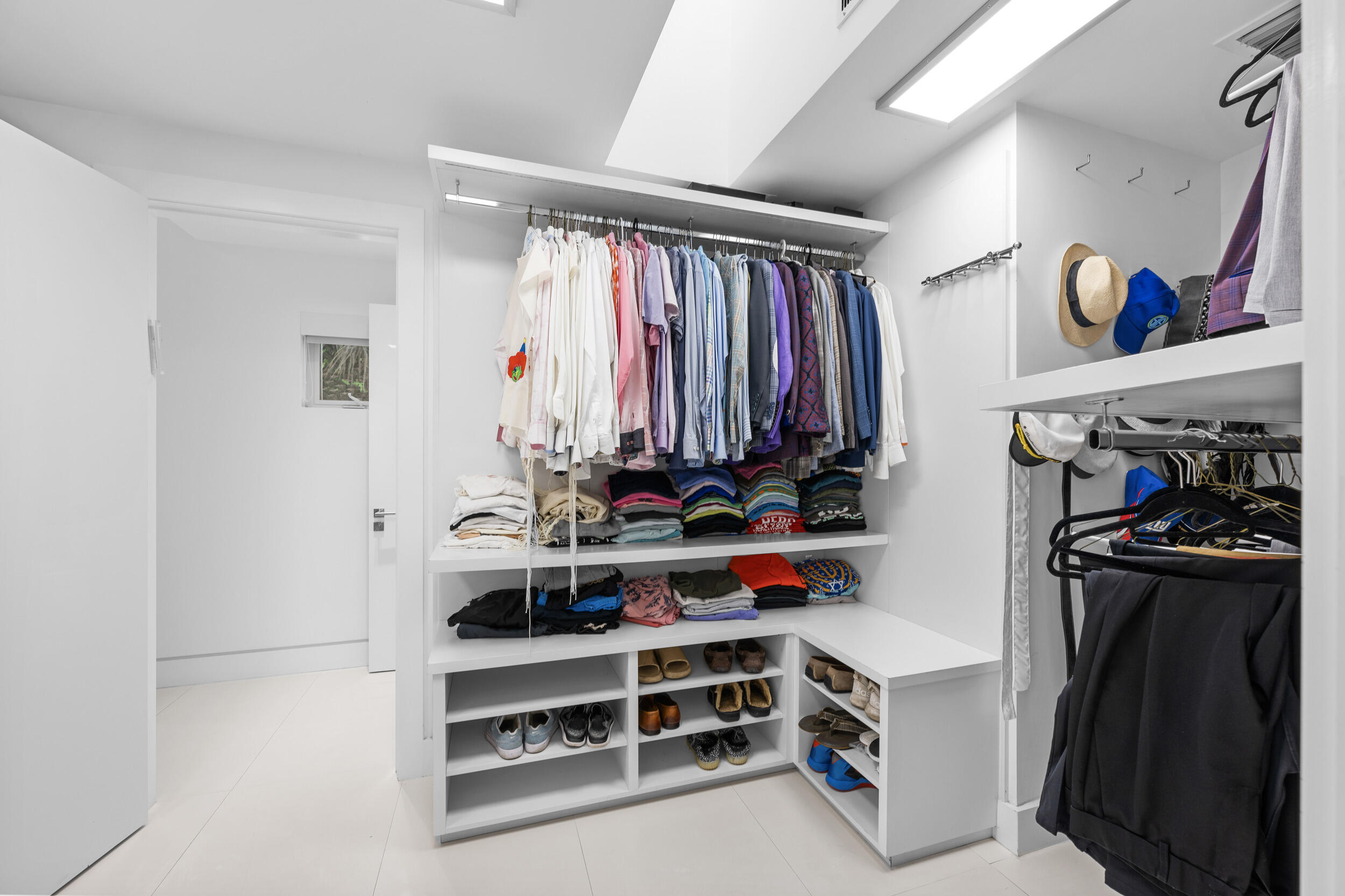 7047 San Sebastian Circle Boca Raton, FL 33433 - Photo 38 of 95 a view of walk in closet with clothes and shoes