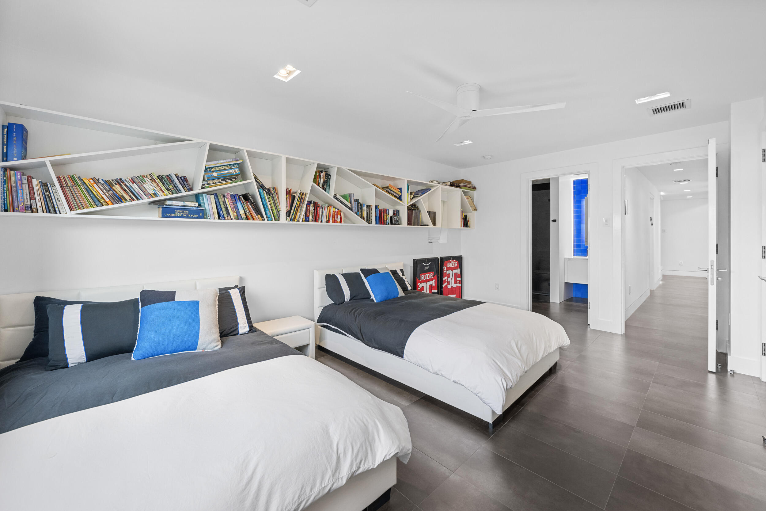 7047 San Sebastian Circle Boca Raton, FL 33433 - Photo 43 of 95 a bedroom with a bed and a book shelf