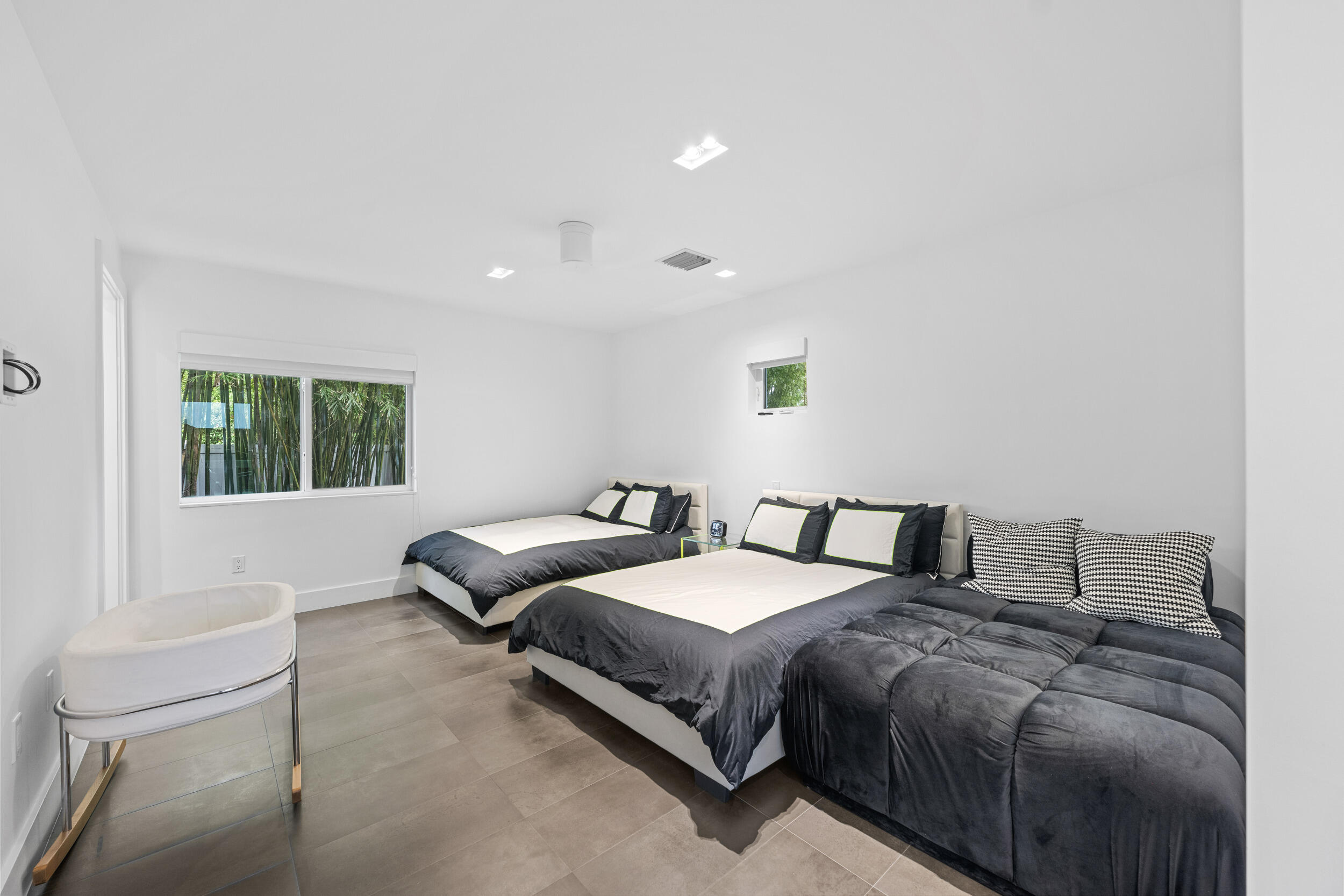 7047 San Sebastian Circle Boca Raton, FL 33433 - Photo 49 of 95 a bedroom with two beds and a couch