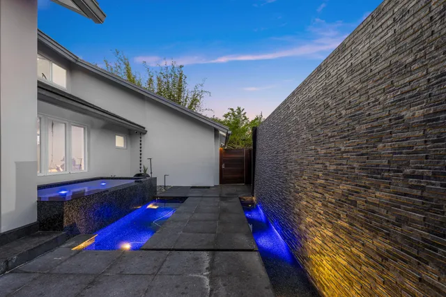 a view of a dining room with furniture and a large window