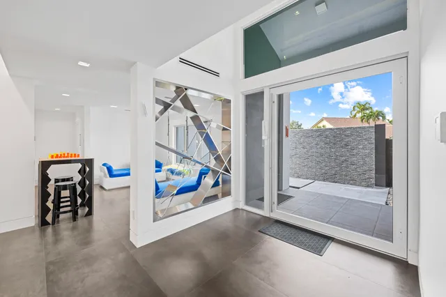 a bedroom with furniture and a large window