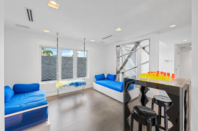 a large kitchen with kitchen island a stove a sink a refrigerator and a dining table with wooden floor