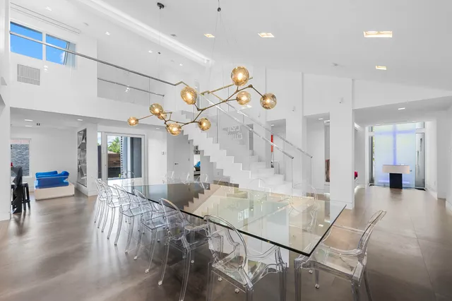 a living room with furniture a window and a chandelier