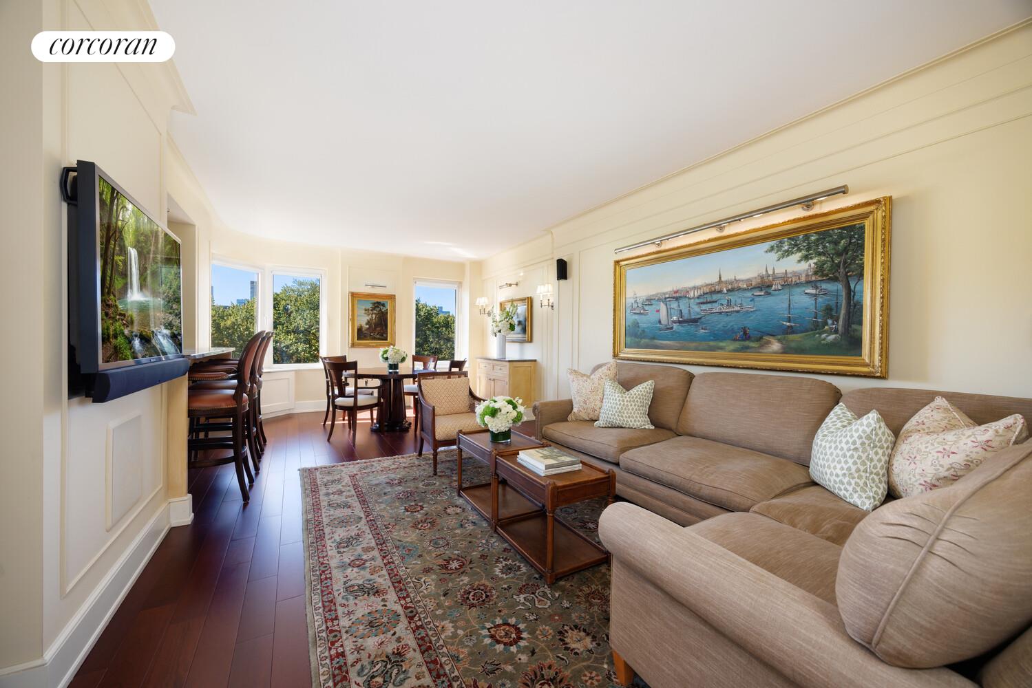 870 5th Avenue, Unit 10/11B Manhattan, NY 10065 - Photo 1 of 14 a living room with furniture two large window and a flat screen tv