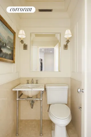 a bathroom with a sink mirror toilet and vanity