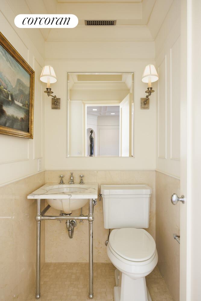870 5th Avenue, Unit 10/11B Manhattan, NY 10065 - Photo 7 of 14 a bathroom with a sink mirror toilet and vanity