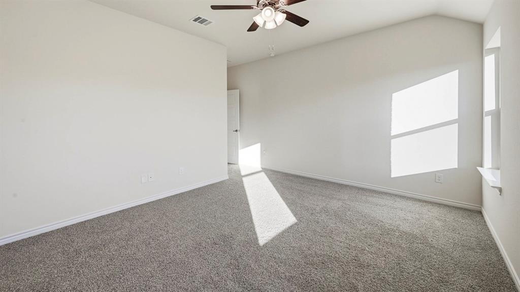 419 Epiphany Lane Lavon, TX 75166 - Photo 17 of 31 Spacious interior room featuring vaulted ceilings, light gray carpeting, and white walls