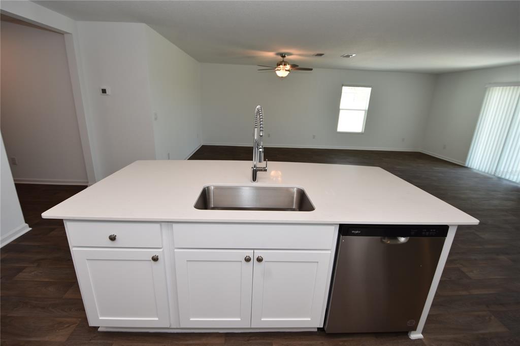 9 Springwood Drive Palm Coast, FL 32137 - Photo 12 of 29 a kitchen with a sink dishwasher and white cabinets