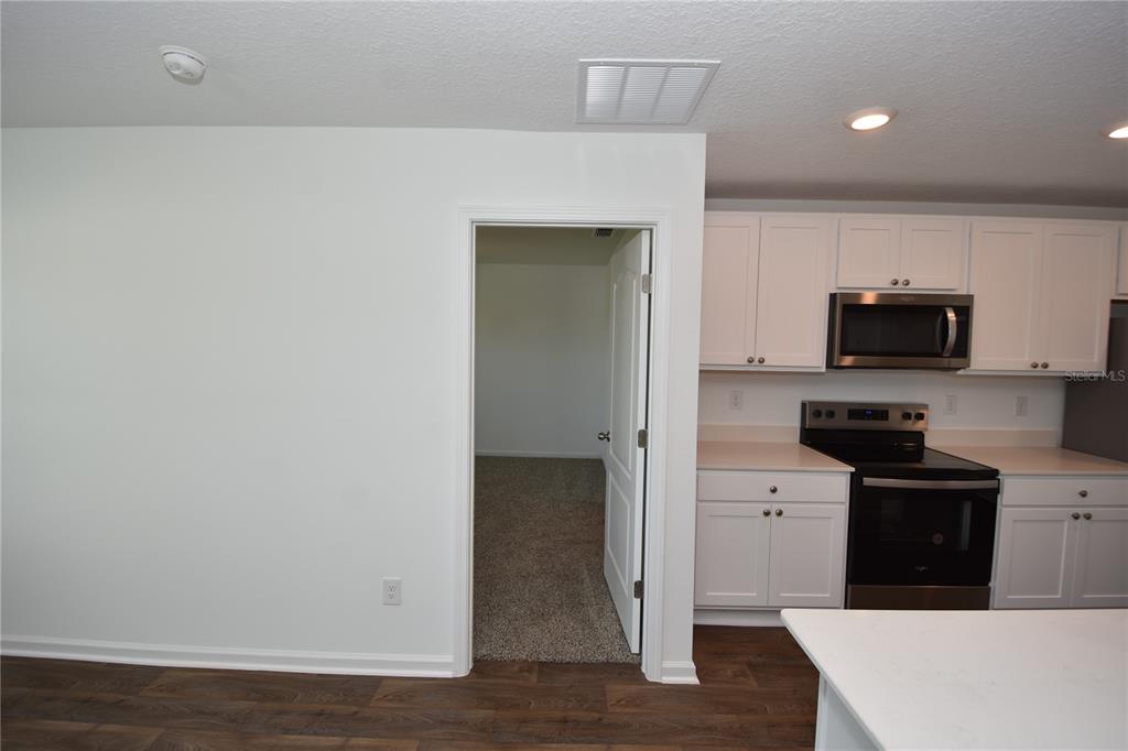 9 Springwood Drive Palm Coast, FL 32137 - Photo 14 of 29 a kitchen with stainless steel appliances a stove top oven a sink and cabinets