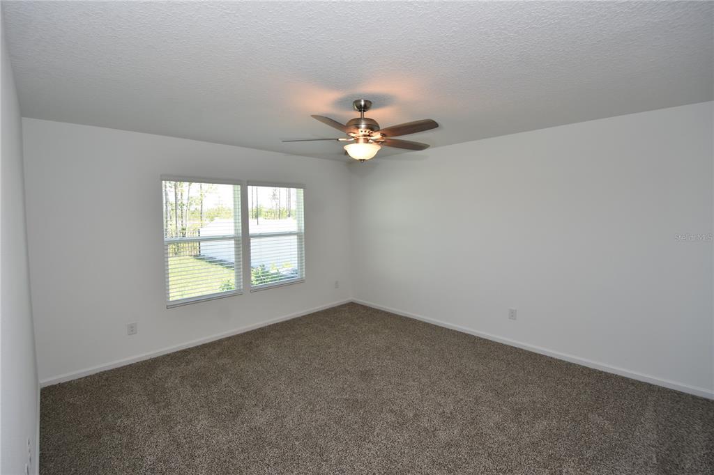 9 Springwood Drive Palm Coast, FL 32137 - Photo 15 of 29 an empty room with a window and a fan