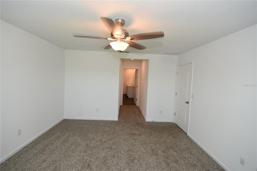 9 Springwood Drive Palm Coast, FL 32137 - Photo 16 of 29 a view of an empty room with a fan