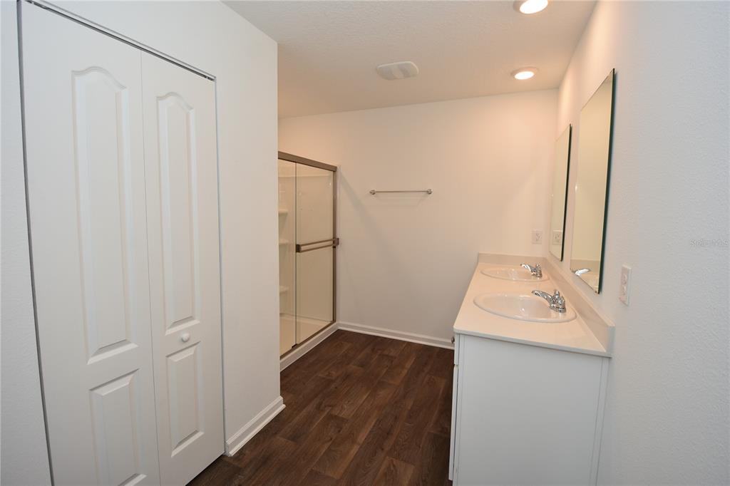 9 Springwood Drive Palm Coast, FL 32137 - Photo 18 of 29 a bathroom with a sink a mirror and shower