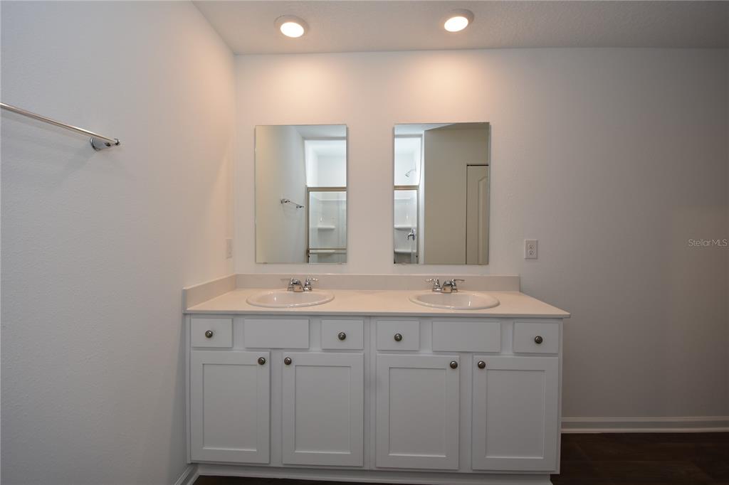 9 Springwood Drive Palm Coast, FL 32137 - Photo 19 of 29 a bathroom with double sink and mirror