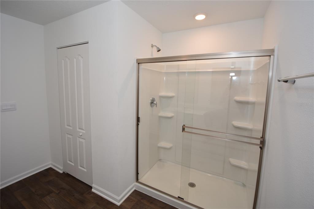 9 Springwood Drive Palm Coast, FL 32137 - Photo 20 of 29 a bathroom with a glass shower door