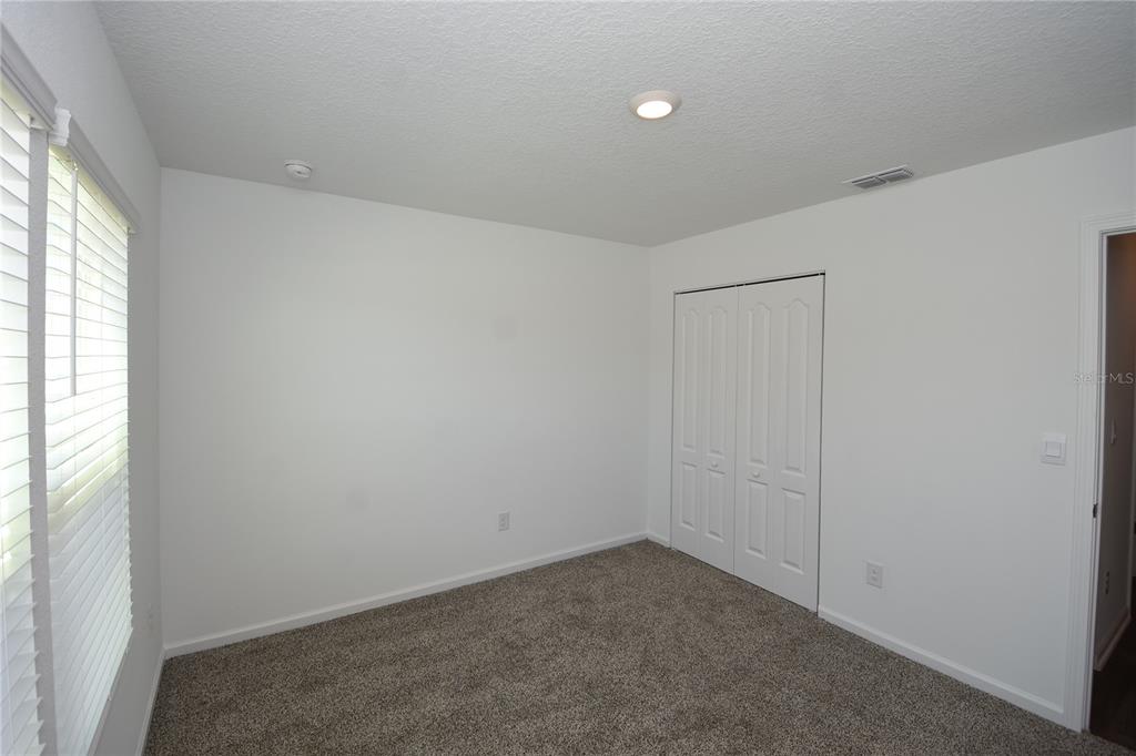 9 Springwood Drive Palm Coast, FL 32137 - Photo 23 of 29 an empty room with a empty space and a window