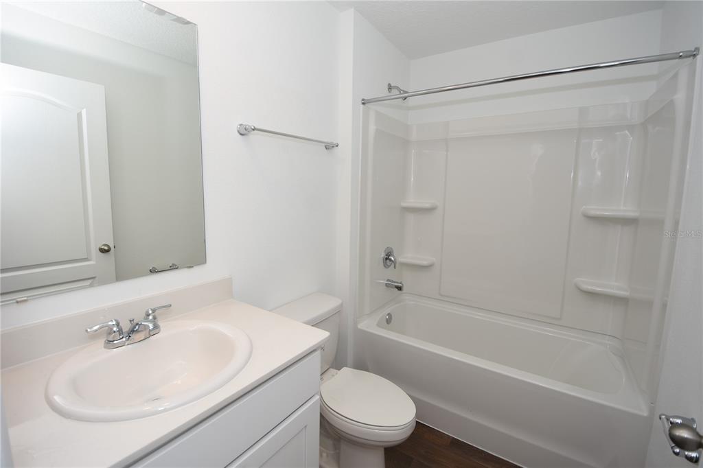 9 Springwood Drive Palm Coast, FL 32137 - Photo 24 of 29 a bathroom with a sink toilet and shower