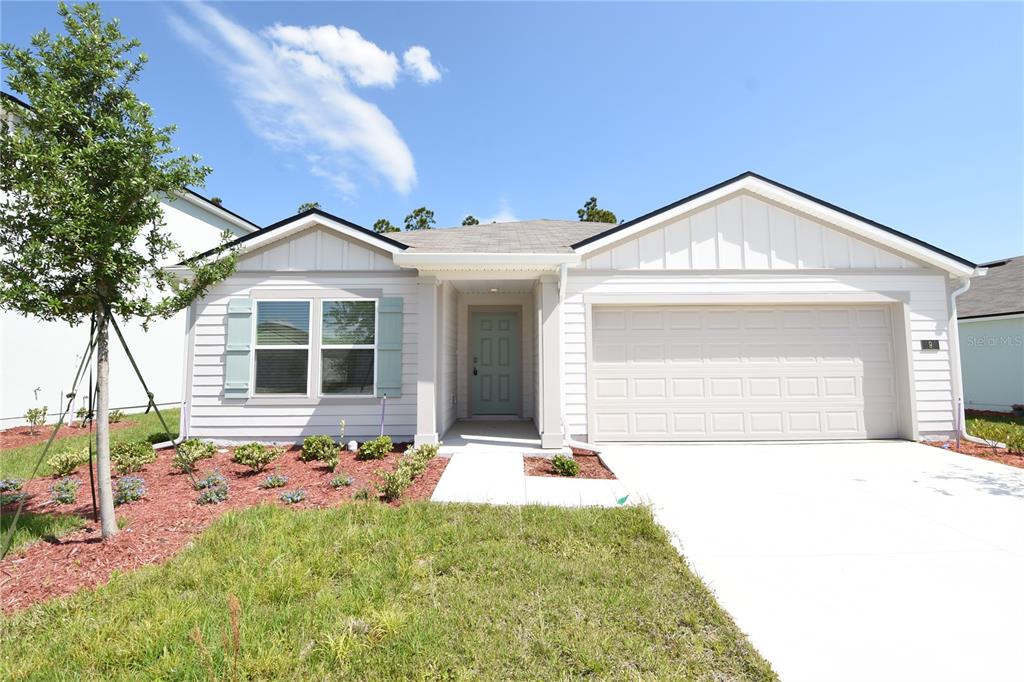 9 Springwood Drive Palm Coast, FL 32137 - Photo 3 of 29 a front view of a house with a yard