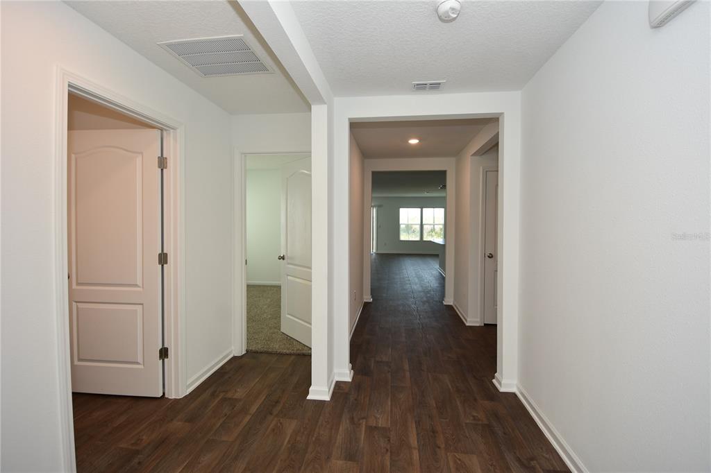 9 Springwood Drive Palm Coast, FL 32137 - Photo 5 of 29 a view of a hallway with wooden floor