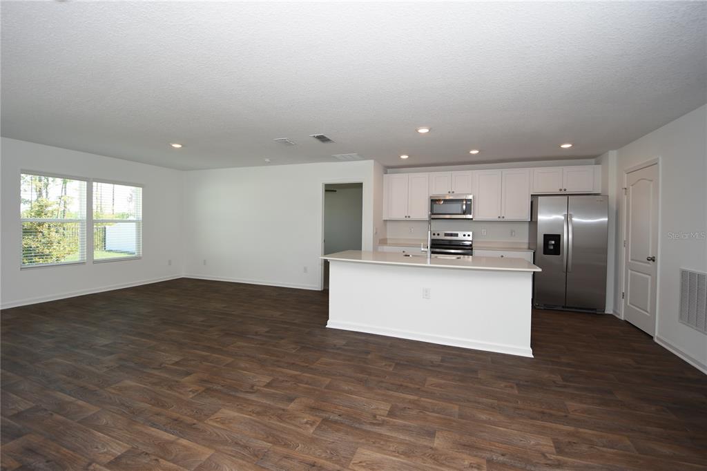 9 Springwood Drive Palm Coast, FL 32137 - Photo 7 of 29 a view of kitchen with stainless steel appliances granite countertop a stove a sink and a microwave