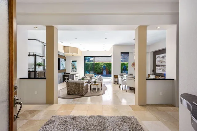 a kitchen with a stove a sink and a dining table